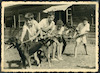 קבוצת הבנים "אייל" אוחזים בחבל אליו קשור הכלב 'עז' ליד צריף המגורים של הקבוצה, קיבוץ שפיים.