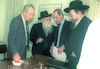 Shimon Peres, of the Labour Party met with Moshe Feldman and other representatives of the Agudat Israel religious party to sign a coalition contract for the next government.