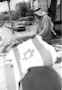 Arab Workers placing Israeli flags in preparation for Independence Day celebrations.