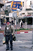 With his right hand raised and wearing his now familiar trilby hat, the Lubavitcher Rebbe looks down benignly on passers-by from many of the illuminated signs that can be seen on many street corners of Israeli towns.