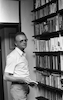 Efraim Kishon famous writer at home with his books.