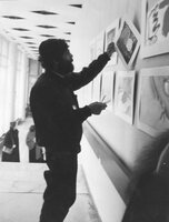 Leningrad, end 1980s - beg. 1990s. (probably 1989-91). An exhibition of children's drawings (probably exhibition "Bet"). I.Dvorkin helps to hang out drawings.