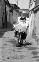 Samarkand, 1992. Sights of mahallah. Teenagers on a moped (negative and photo).