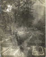 Soldier standing in Christian cemetery, Italy.