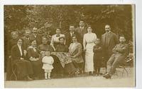 Group portrait in Bad Brückenau of sixteen individuals, some around an outdoor table. Late 19th century.