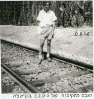 הנער דוד כתר עומד על מסילת הרכבת כשידו מגובסת, ירושלים.