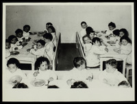 Children taking their meal in the dining room.