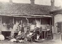 Victims of Kishinev pogrom posed in front of a destroyed house, 1903.