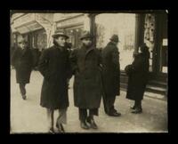 [Two men walking in street].