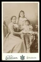 Photograph of a women with two children.