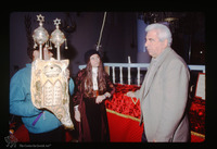 Photograph of: Torah reading in the Kal Yavanim (Greca) Synagogue in Trikkala, Greece : Holding the Torah.