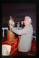 Photograph of: Torah reading in the Kal Yavanim (Greca) Synagogue in Trikkala, Greece : Removing the Finials.