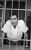 Ofer Eshed Captain of the National Basket ball team, was cought behind a fence but not in jail just in his office in Tel Aviv.