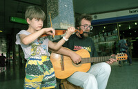 Poverty of the new immigrants from the Soviet Union pushed a father and his child to perform on the streets for passers by asking for their generosity and donation.