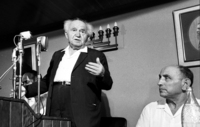 Ben Gurion addressing the audience of the Labour Party members while former Chief of the Inteligence Department Isser Harel is sitting next to him.