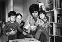 The Shohat family celebrating the Hanukka festival by lightning the traditional candles.