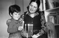 The Shohat family celebrating the Hanukka festival by lightning the traditional candles.