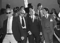 PM Menahem Begin descending steps with his advisors: left- Yehiel Kadishai.