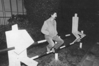 Sculpturer Dan Zaritzki sitting next to his work.
