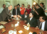 Shimon Peres, of the Labour Party met with Moshe Feldman and other representatives of the Agudat Israel religious party to sign a coalition contract for the next government.