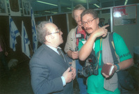 Photographers interviewing an immigrant from the Soviet Union.