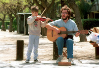 Poverty of the new immigrants from the Soviet Union pushed a father and his child to perform on the streets for passers by asking for their generosity and donation.
