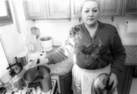 Wife of Dan Tichon, Ludmila cooking at her home.