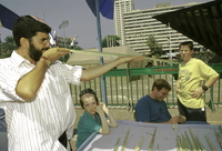 Orthodox Jews inspecting examples of the four species of Succot for possible defects - on the eve of the holiday at Tel Aviv Malchei Yisrael, 18 September 1994.