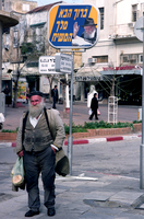 With his right hand raised and wearing his now familiar trilby hat, the Lubavitcher Rebbe looks down benignly on passers-by from many of the illuminated signs that can be seen on many street corners of Israeli towns.