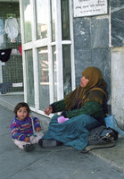 A young Arab mother from Gaza Strip begging for some money with her child in the strets of Tel Aviv.