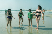 Playing sea shore tennis on the Tel Aviv beach.