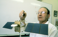 Prof. Yuval Neeman pointing of the Israeli Communication satelite 'Amos' which will by launched in the near future.