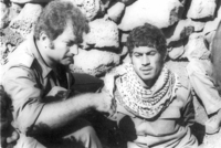 Eli Landau giving drinking water to an Egyptian POW.