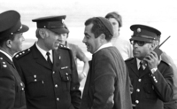 Rabbi Kahane Meir speaking with police officers while demonstrating in Tel Aviv.