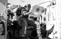 Reading a newspaper sittng next to the cannon shells.