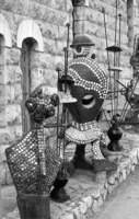 The Yemin Moshe Quarter in Jerusalem with a statue next to a art gallery.