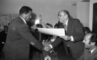 Labour Minister Josef Akmogi presents a certificate to a Gaza man on completion of a surveyors course organized by the Ministry.