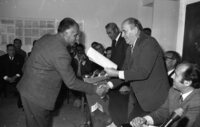 Labour Minister Josef Akmogi presents a certificate to a Gaza man on completion of a surveyors course organized by the Ministry.