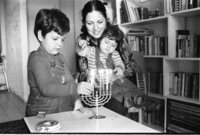 The Shohat family celebrating the Hanukka festival by lightning the traditional candles.