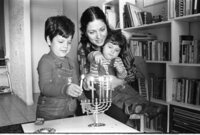 The Shohat family celebrating the Hanukka festival by lightning the traditional candles.