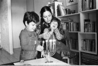 The Shohat family celebrating the Hanukka festival by lightning the traditional candles.