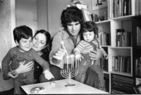 The Shohat family celebrating the Hanukka festival by lightning the traditional candles.