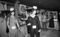 Two police women from West germanyexamine adisplay of Israeli equipment at the International Police association's annual convention which was opened today in Tel Aviv, Attending are 320.