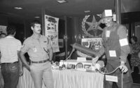 Two police women from West germanyexamine adisplay of Israeli equipment at the International Police association's annual convention which was opened today in Tel Aviv, Attending are 320.