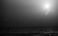 A beautiful shot of a fool moon with a boat at sea.